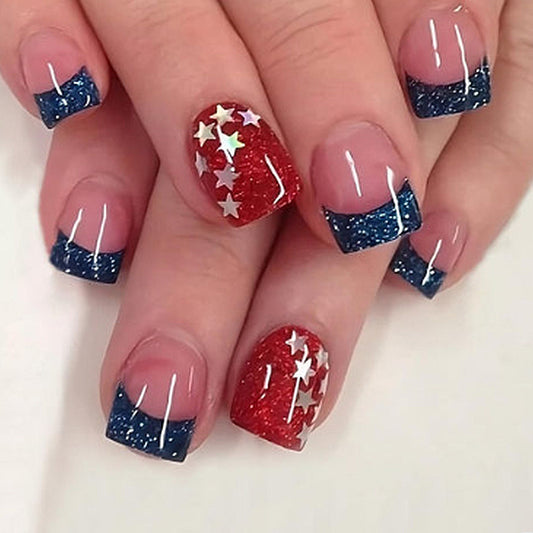 A set of press-on nails featuring a patriotic design with red, blue, and white colors, accented with glitter stars.