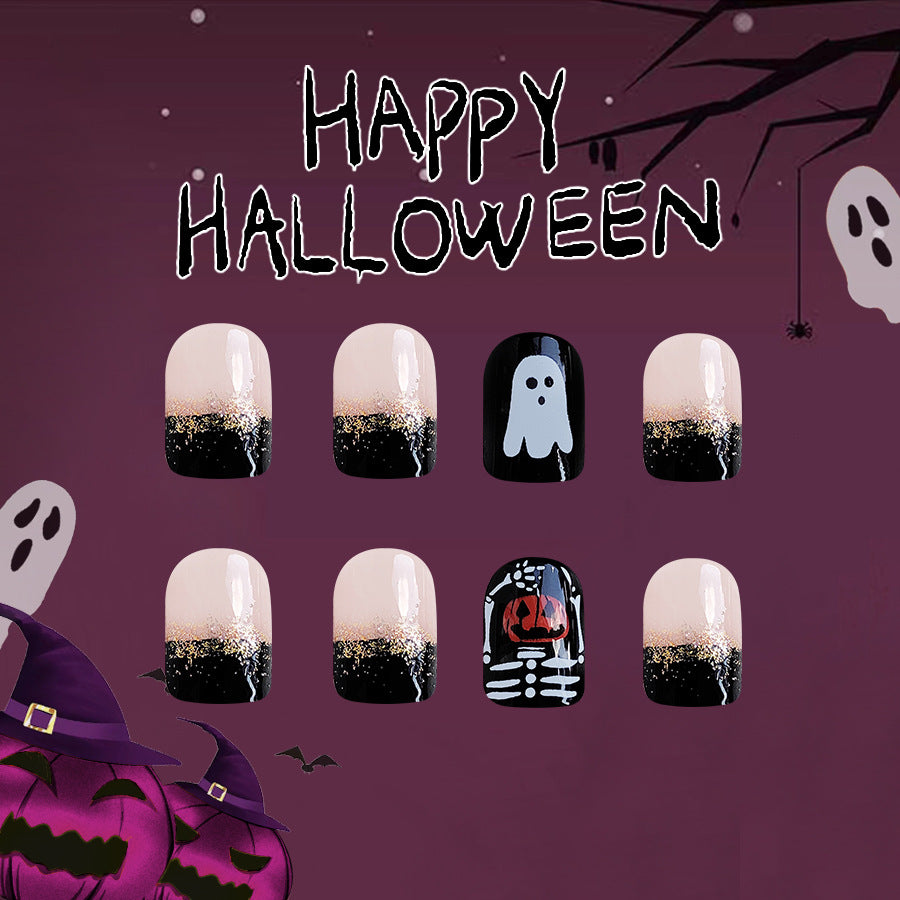 A set of press-on nails with a Halloween theme, featuring designs such as ghosts, skeletons, and pumpkins on a dark background.