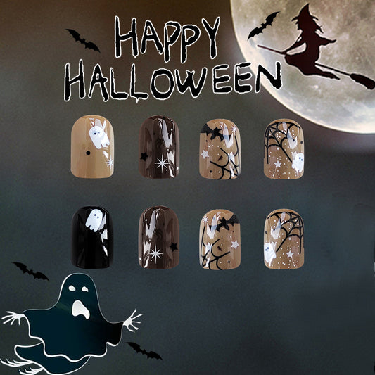 A collection of Halloween-themed press-on nails featuring designs like ghosts, pumpkins, and bats with glitter accents, displayed against a moonlit background.