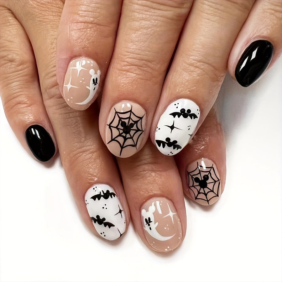 Spooky Elegance Short-Length Oval Press On Nail Set in Black and White with Halloween Motifs Design