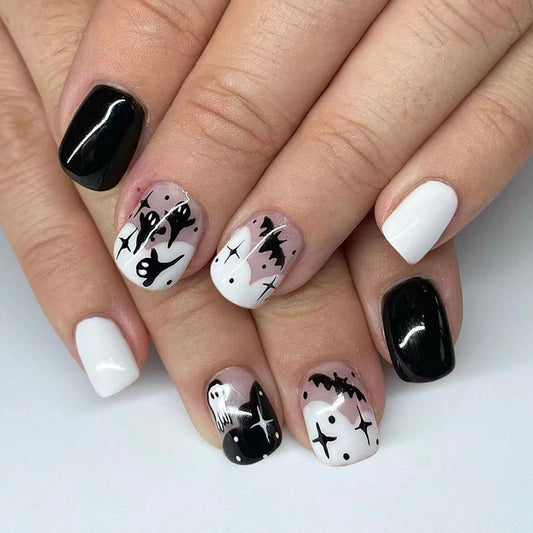 Spooky Elegance Short Length Oval Shape Black and White Press On Nail Set with Ghost and Bat Design