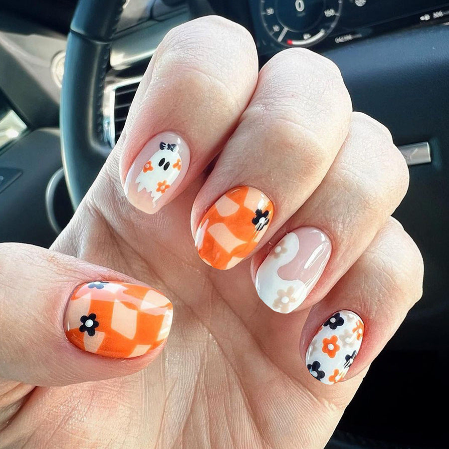 Spooky Elegance Short Length Oval Press On Nail Set in Orange and White with Ghost Accents and Floral Patterns