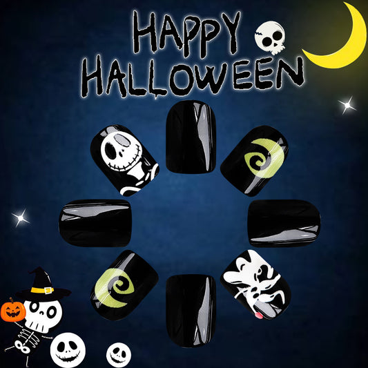 A set of black square press-on nails with various Halloween-themed designs including a skull, pumpkin, and ghosts.