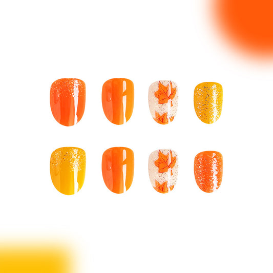 Autumn Bliss 24 Medium Oval Press On Nail Set in Vibrant Orange and Yellow with Sparkling Accent and Leaf Design