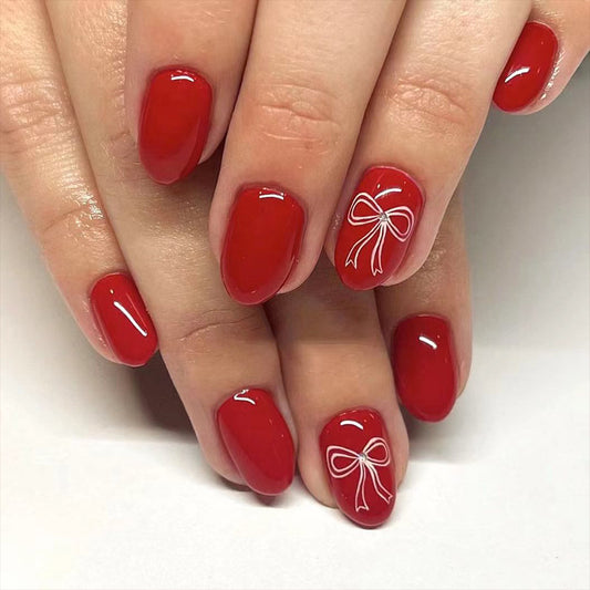 Charming Celebration Theme Medium Oval Red Press On Nail Set with Elegant White Bow Design