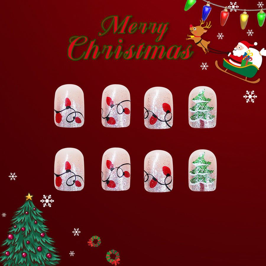 A set of press-on nails featuring a Christmas theme, with designs including red and green glitter, and festive patterns such as lights and a Christmas tree.