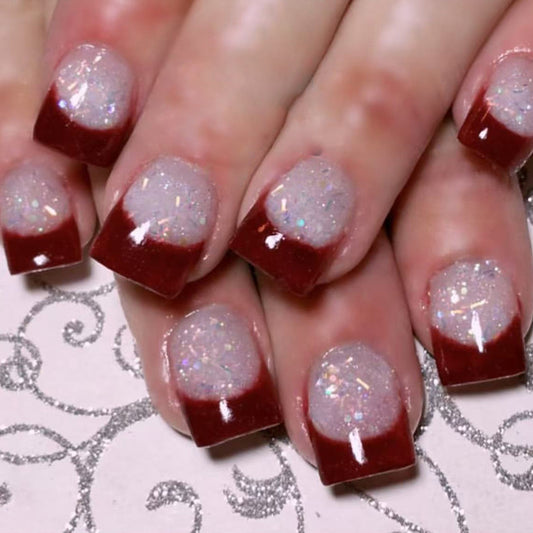 Nails with red and white glitter design on a decorative background
