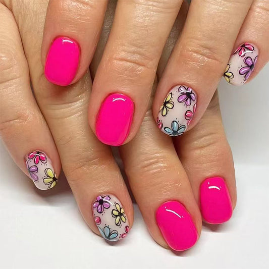 A set of press-on nails featuring a bright pink color with a floral pattern on the nails with a design of multiple small multicolored flowers.