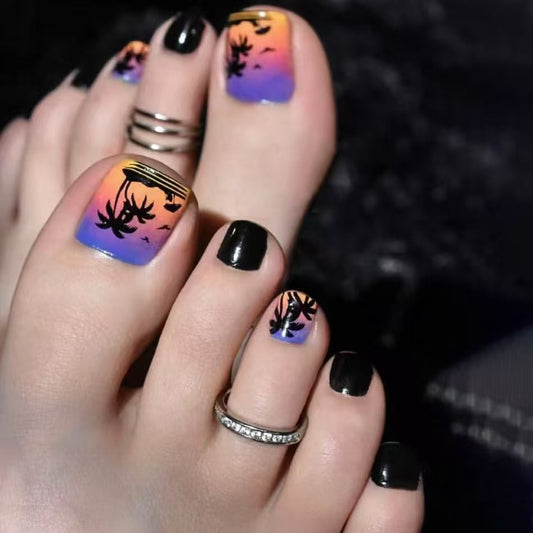 Nails with a sunset design and black leaf shapes on a multicolored background