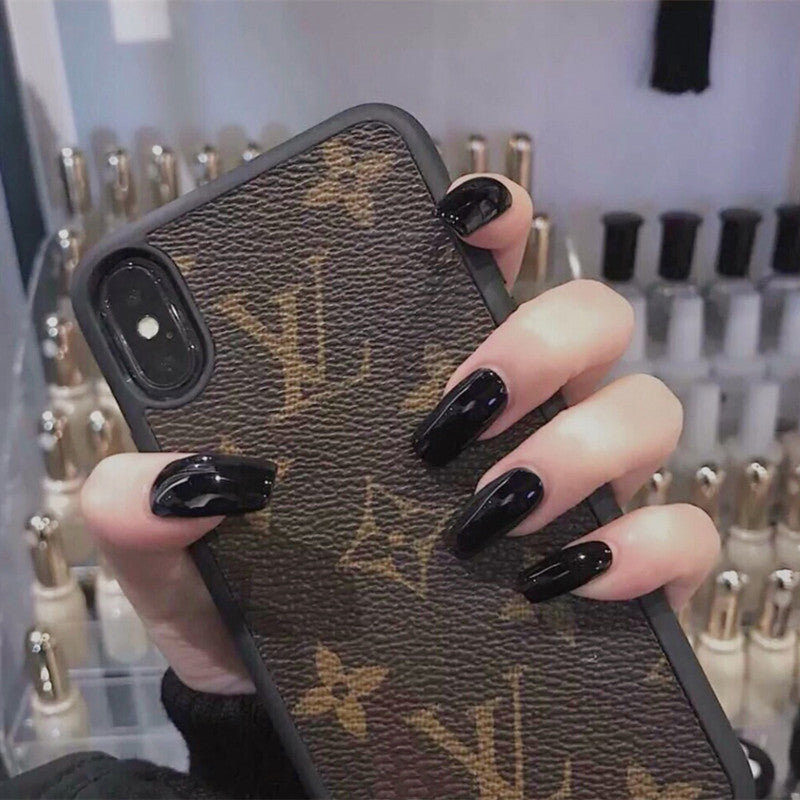 Hand holding a phone case with a brand logo, with nail polish visible