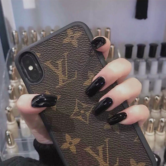 Hand holding a phone case with a brand logo, with nail polish visible