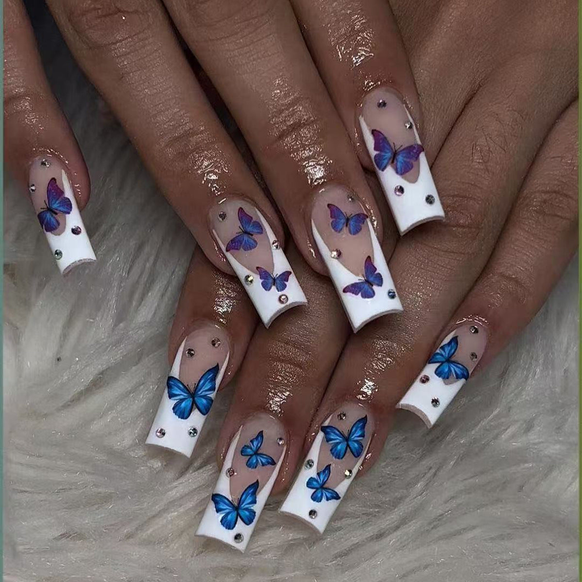 Whimsical Butterfly Dreams Long Square White Nails with Blue Floral Accents and Sparkling Rhinestones
