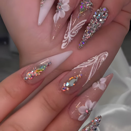 Whimsical Elegance Long Stiletto White and Clear Nails with Intricate Floral and Gemstone Accents
