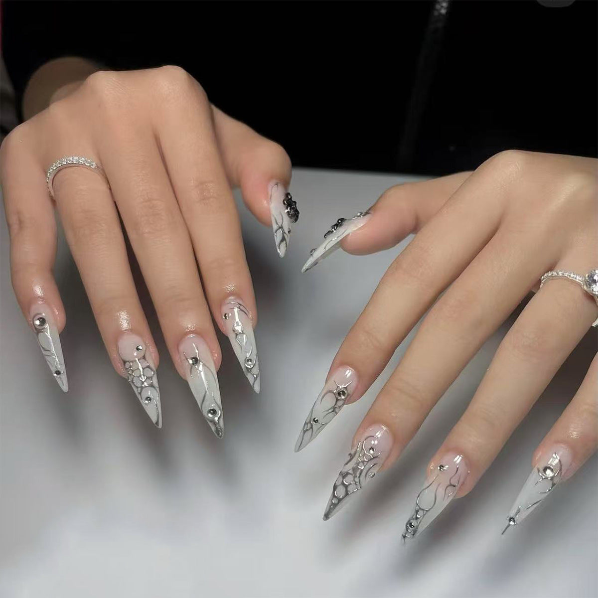 Enchanted Elegance Long Stiletto Shaped Silver Press On Nail Set with Artistic Swirls and Gem Accents