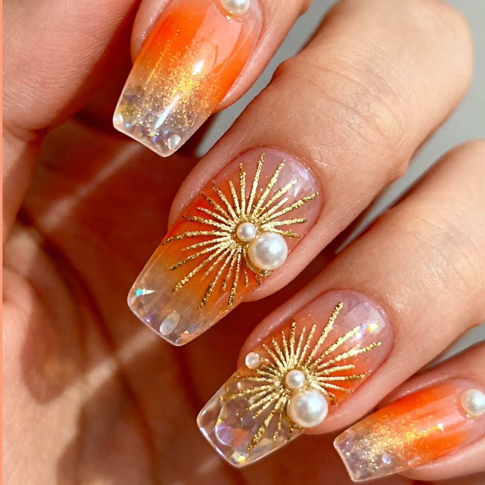 Sunset Radiance Medium Square Orange Gradient Press-On Nail Set with Elegant Gold Starburst Design and Pearl Accents