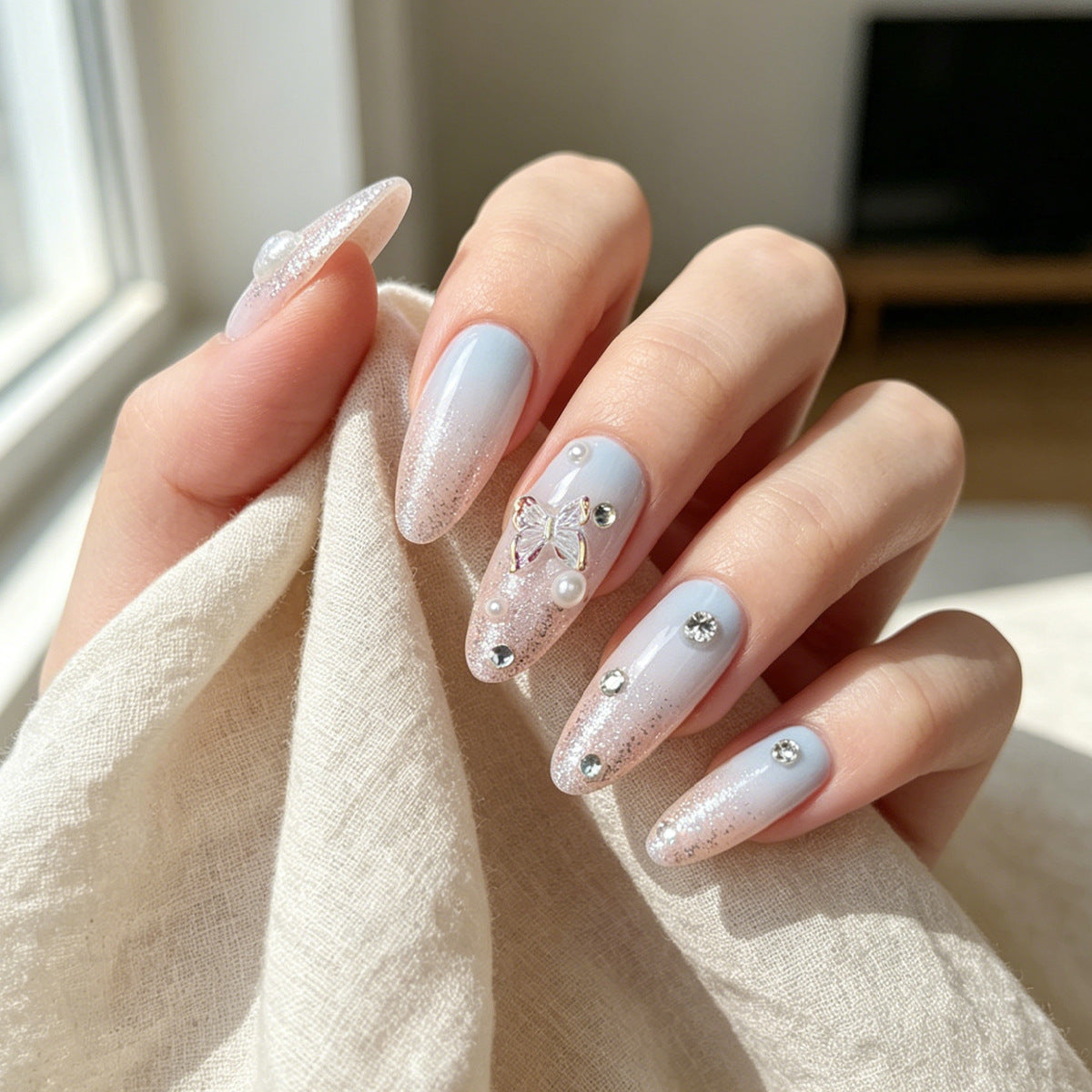 Whimsical Elegance Medium Almond Light Blue Glittery Nail Set with Butterfly Charm