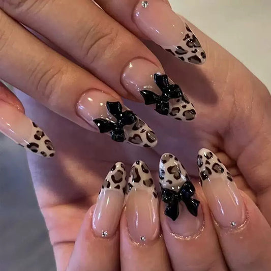 Wild Safari Inspired Medium Almond Beige Leopard Print Nails with Black Bow Accents