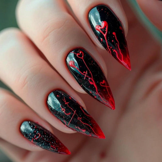 A close-up image of a person's fingernails, which are painted with a black nail polish with red heart accents and a sparkling finish.