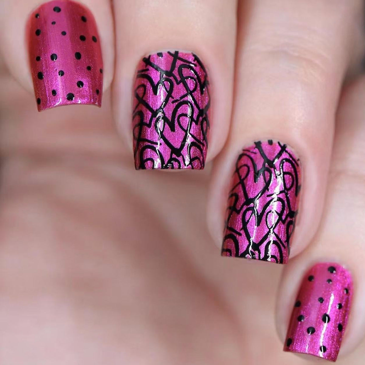 A set of short square glossy pink nails with a romantic heart design