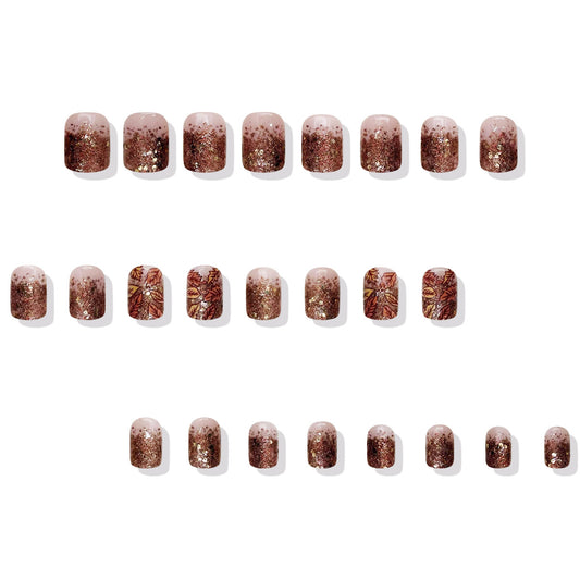 Row of glittery nail art stickers on a white background