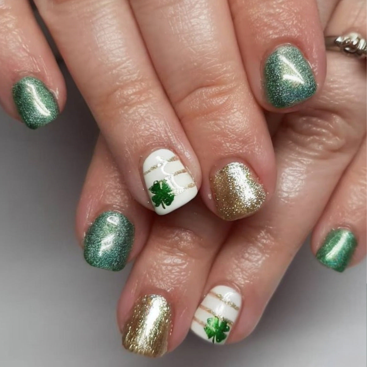 Festive Shamrock Dreams Short Square Green and Gold Glitter Press-On Nail Set with Unique White Accent Design