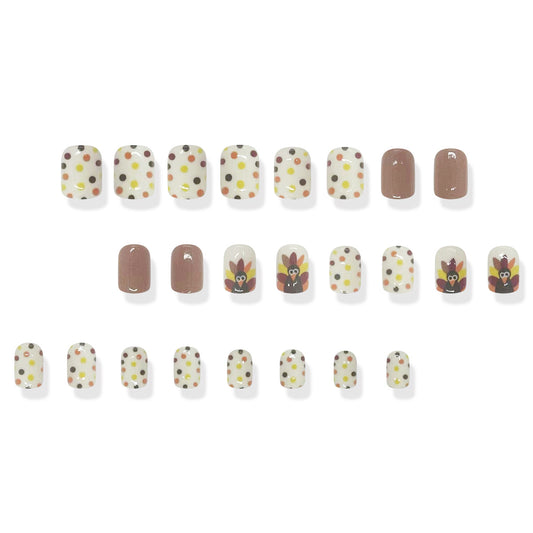 A set of press-on nails featuring a variety of designs, including some with glitter, dots, and a turkey pattern.