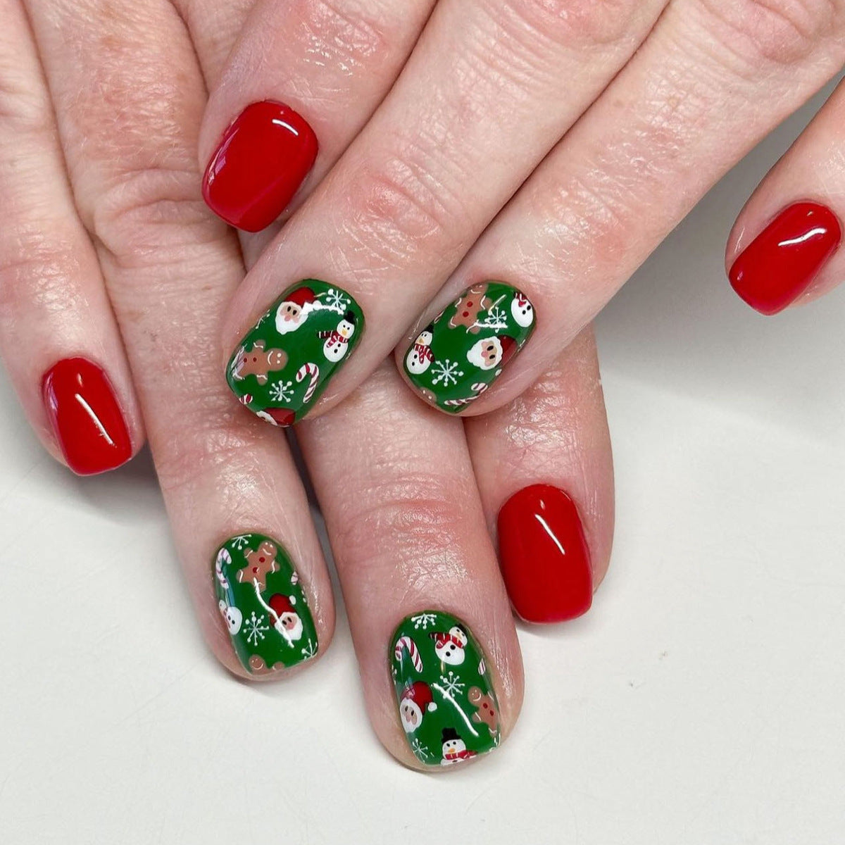 Festive Holiday Magic Short Round Red and Green Decorative Press On Nail Set with Santa and Gingerbread Designs