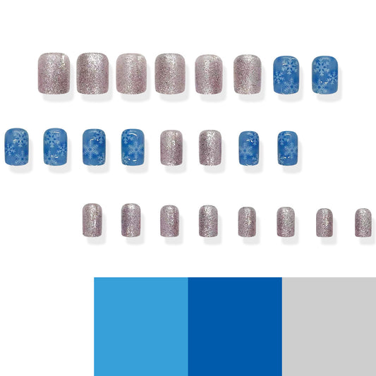 A set of press-on nails featuring a variety of designs, including some with glitter and blue snowflake patterns.