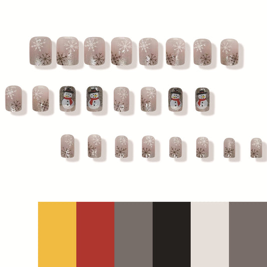 A set of press-on nails with a winter theme, featuring designs of snowflakes and a snowman in soft pink, gray, and glitter colors.