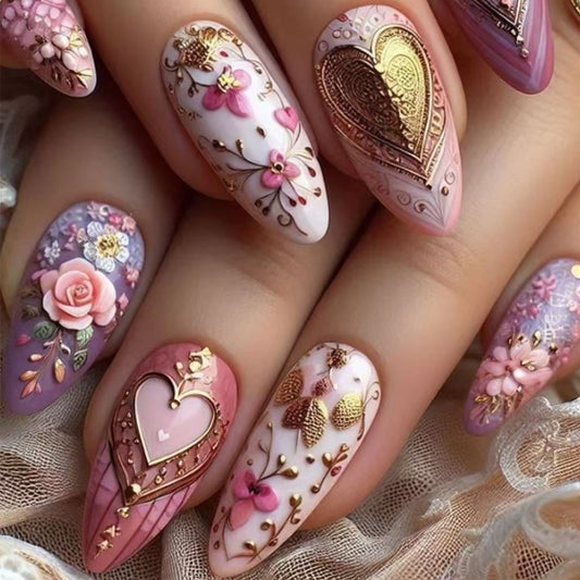 Decorative nail art with floral and heart designs on a textured fabric background