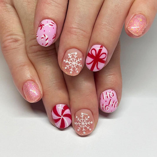 Holiday Wonderland Short Oval Pink Candy Themed Press On Nail Set with Glitter and Festive Designs