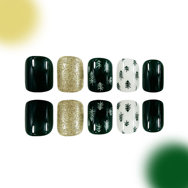 A set of false nails with a variety of designs, including solid black, gold sparkle, and pine tree patterns.