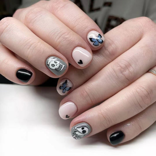 Spooky Delight Short Oval Black and Pink Press On Nail Set with Unique Butterfly and Skull Design
