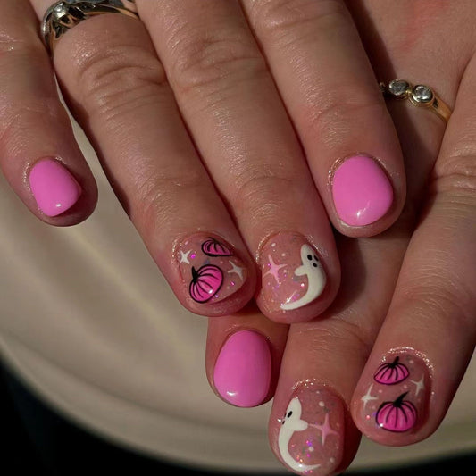 Spooky Glam Short Oval Pink Press On Nail Set with Whimsical Ghost and Pumpkin Designs