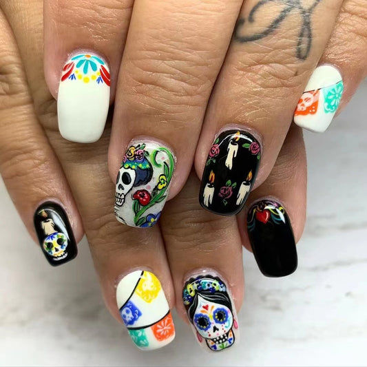 A set of colorful press-on nails featuring unique sugar skull designs, long, and square in shape.