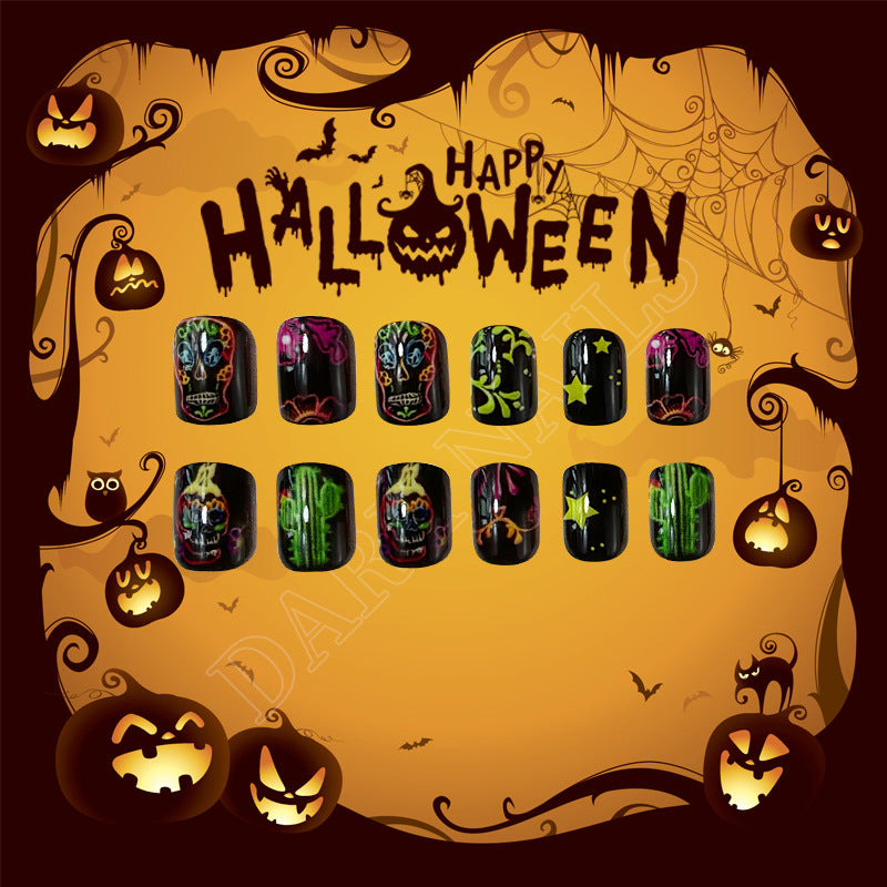 Spooky Halloween Themed Short Oval Black and Colorful Skull Press On Nail Set with Intricate Glow in the Dark Designs