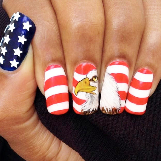 A set of press-on nails featuring a long square design with red, white, and blue sections and an eagle motif.