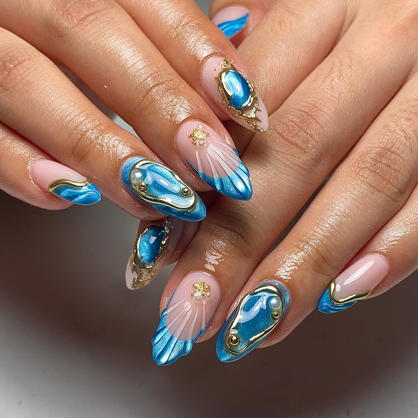 Oceanic Elegance Long Almond Blue Metallic Marble Press-on Nail Set with Gold Accents