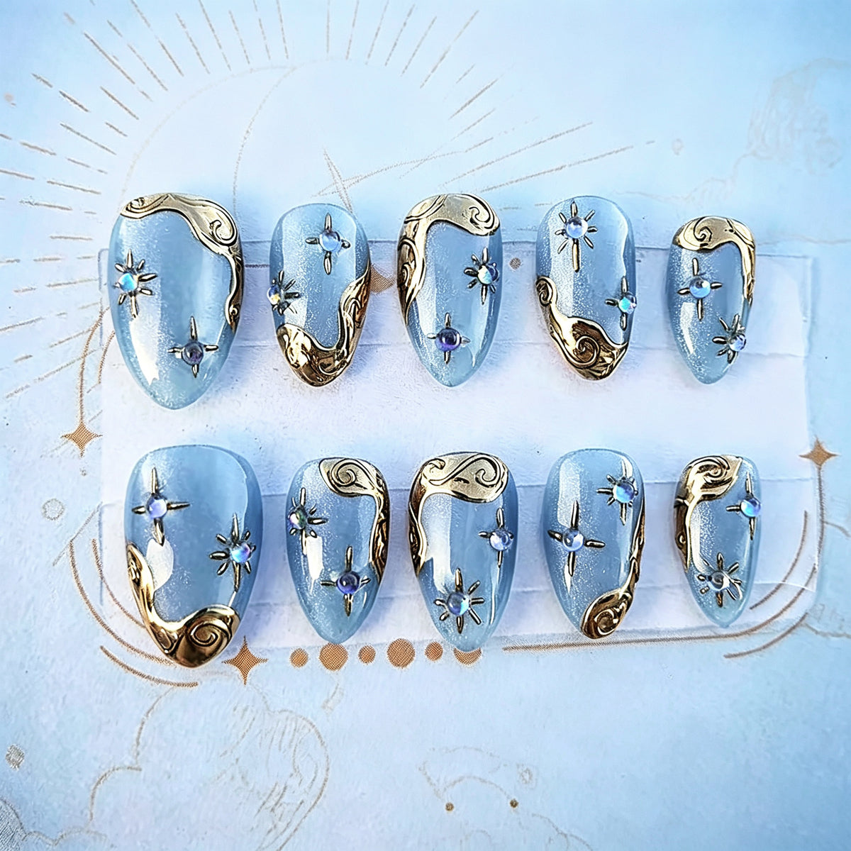 Celestial Dreams Medium Almond Blue Nails with Elegant Golden Accents