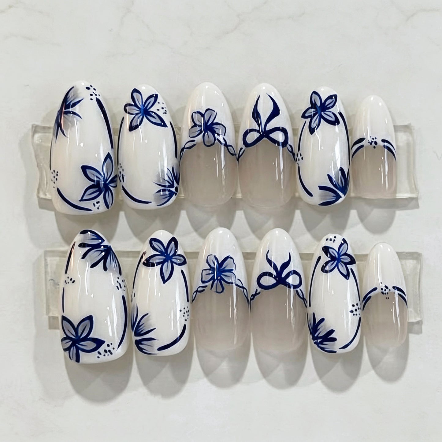 Enchanted Floral Medium Almond White Press On Nail Set with Elegant Blue Design