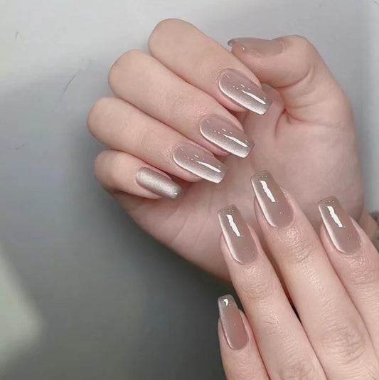 Hand with clear nail polish on a plain background