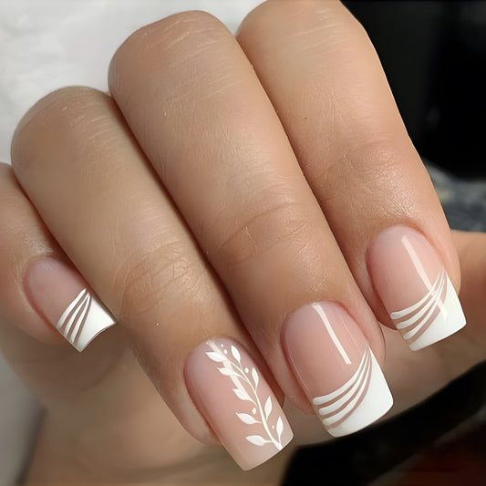 Close-up of a hand with beige nail polish and white decorative patterns.