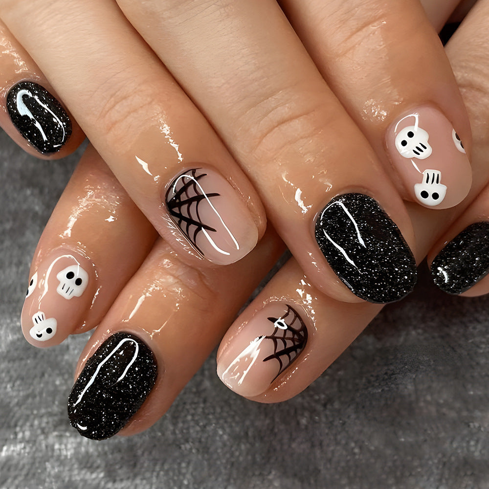 Spooky Chic Short Oval Black and Beige Press On Nail Set with Glitter and Skull Designs