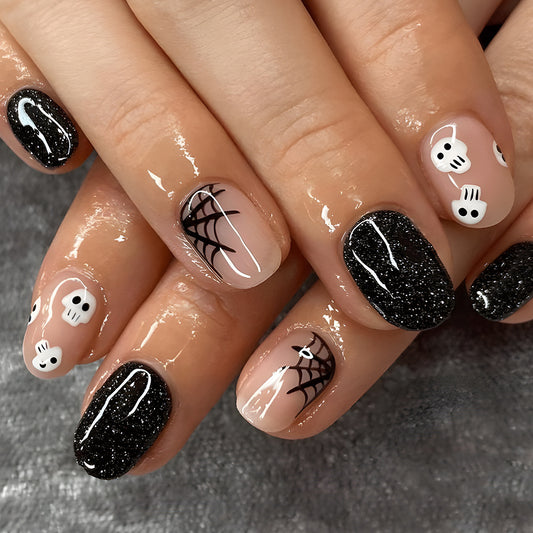 Spooky Chic Short Oval Black and Beige Press On Nail Set with Glitter and Skull Designs