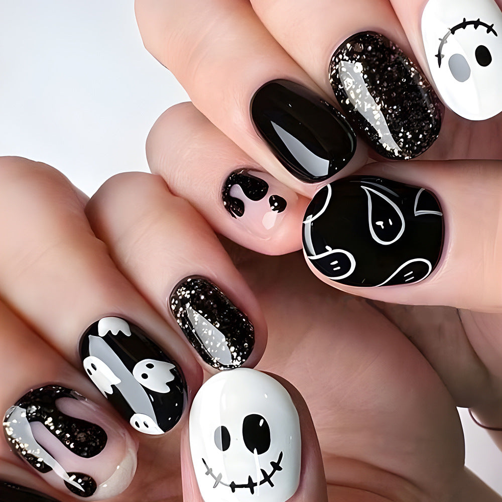 Spooktacular Short Oval Black and White Nail Set Featuring Ghost and Glitter Designs
