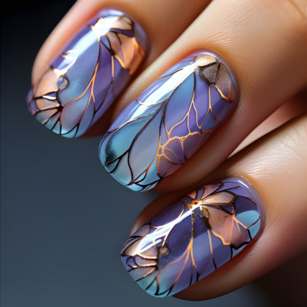 Nails with floral design and metallic accents on a dark background