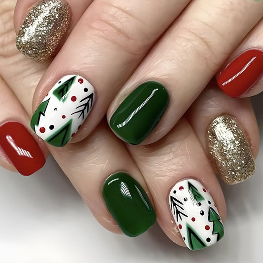 A set of press-on nails featuring a Christmas tree design with green, red, white, and gold colors.