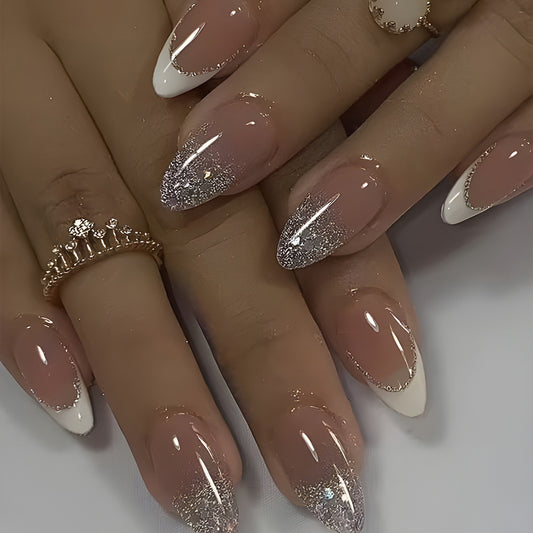 A set of press-on nails featuring a shimmering silver ombre design with a medium almond shape.