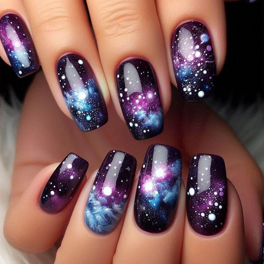 Nails with galaxy design on a hand