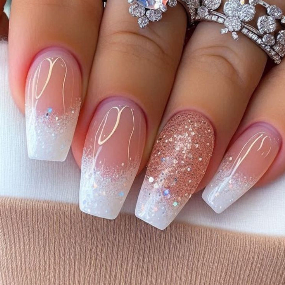 Nails with pink and white gradient design on a beige background